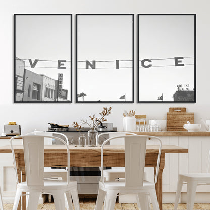 Black and white photo of Venice Beach sign and palm-lined street, perfect for urban coastal or minimalist LA-inspired wall decoration.