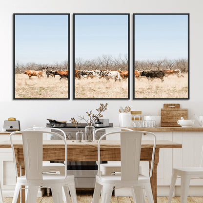 Framed wall art of Texas longhorn cattle walking through a dry, neutral-toned prairie, perfect for rustic farmhouse or western-themed home decor.