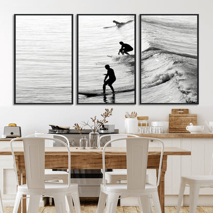 Black and white photo of surfers riding waves in a moody, high-contrast scene, ideal for modern coastal or surf-inspired home decor.