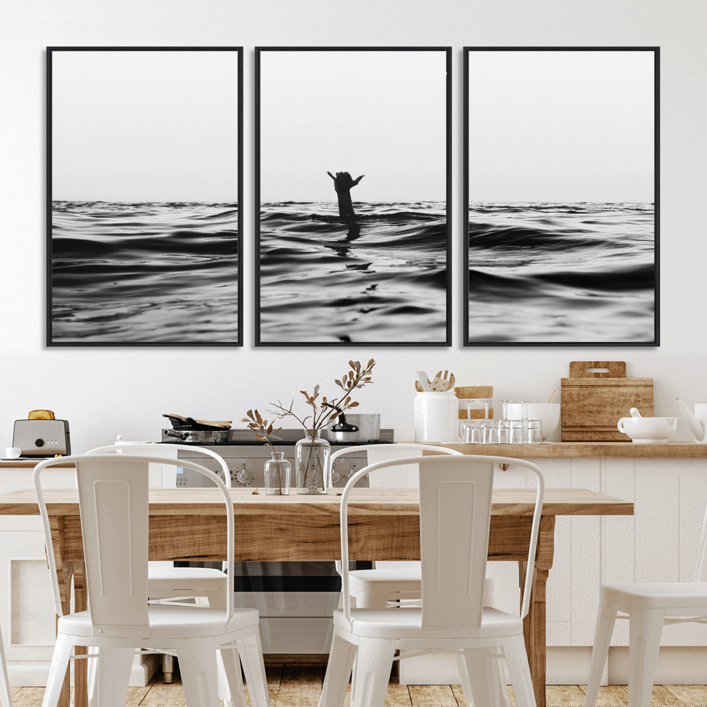Black and white ocean with a hand making a surfer sign among dark waves, creating a dramatic and minimalist seascape with bold contrast.