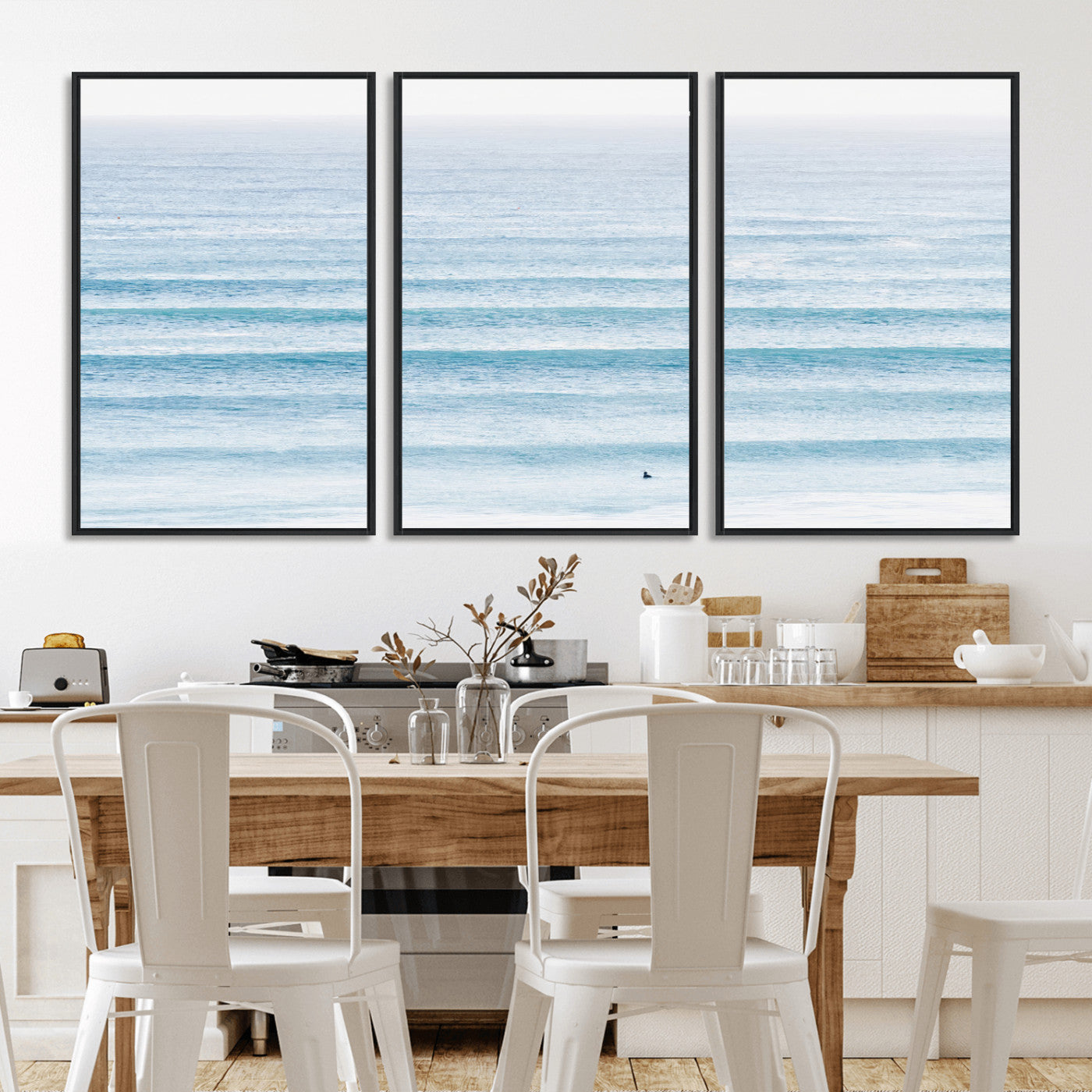 Minimalist ocean view with soft blue waves and a lone surfer, creating a serene and airy coastal aesthetic, perfect for tranquil home decor.
