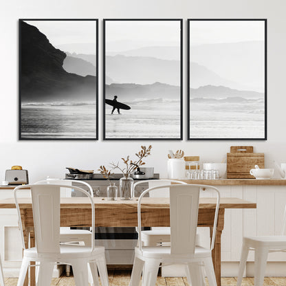 A lone surfer walking along a misty beach with cliffs in the background, carrying their board, capturing a serene and minimal ocean moment.
