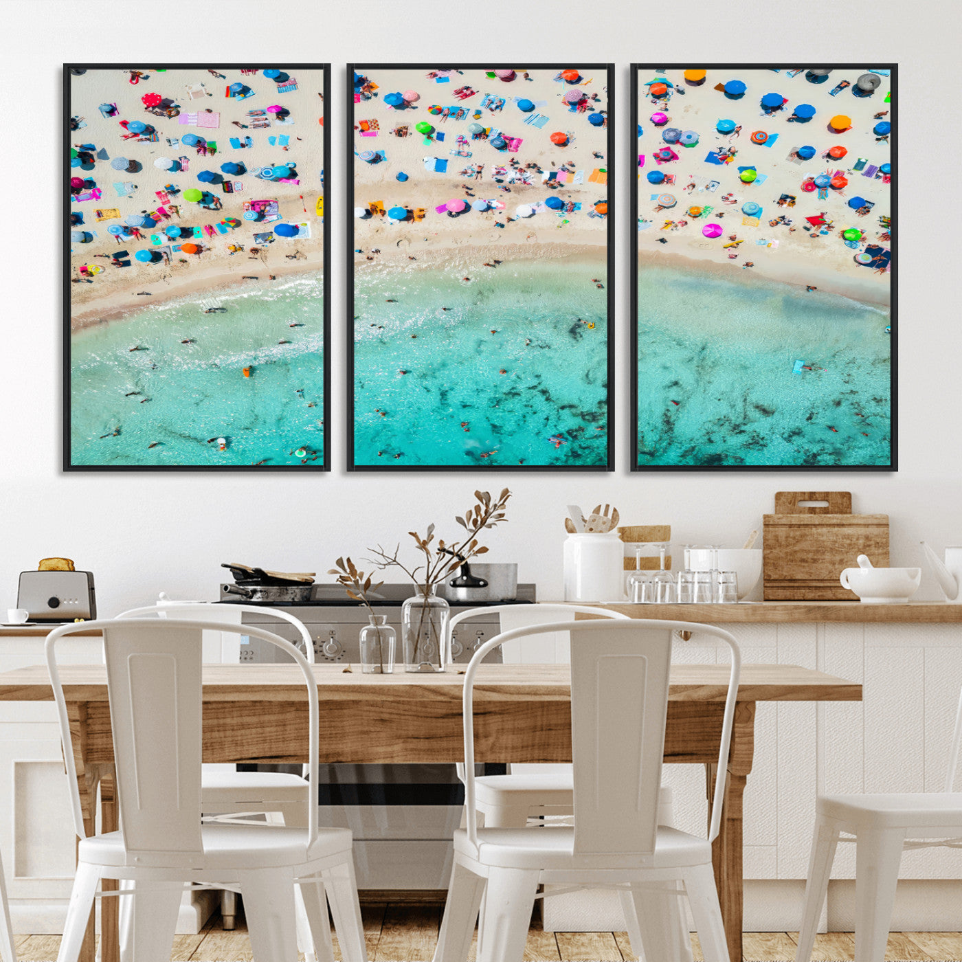 Aerial view of a vibrant beach filled with colorful umbrellas and people enjoying the turquoise ocean, capturing a lively summer vacation scene.