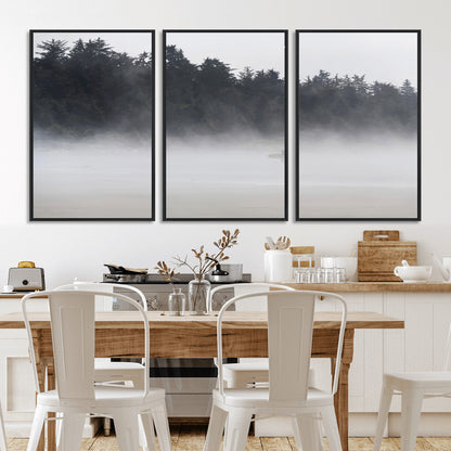 A lone surfer carrying a board through a misty shoreline, surrounded by dense trees and fog, creating a peaceful and mysterious coastal scene.