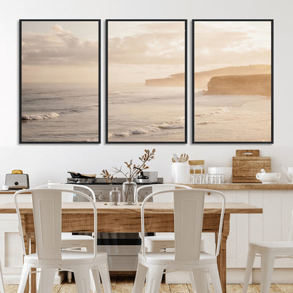 Golden hour seascape with misty cliffs and gentle waves rolling towards the shore, capturing a tranquil and warm coastal atmosphere.