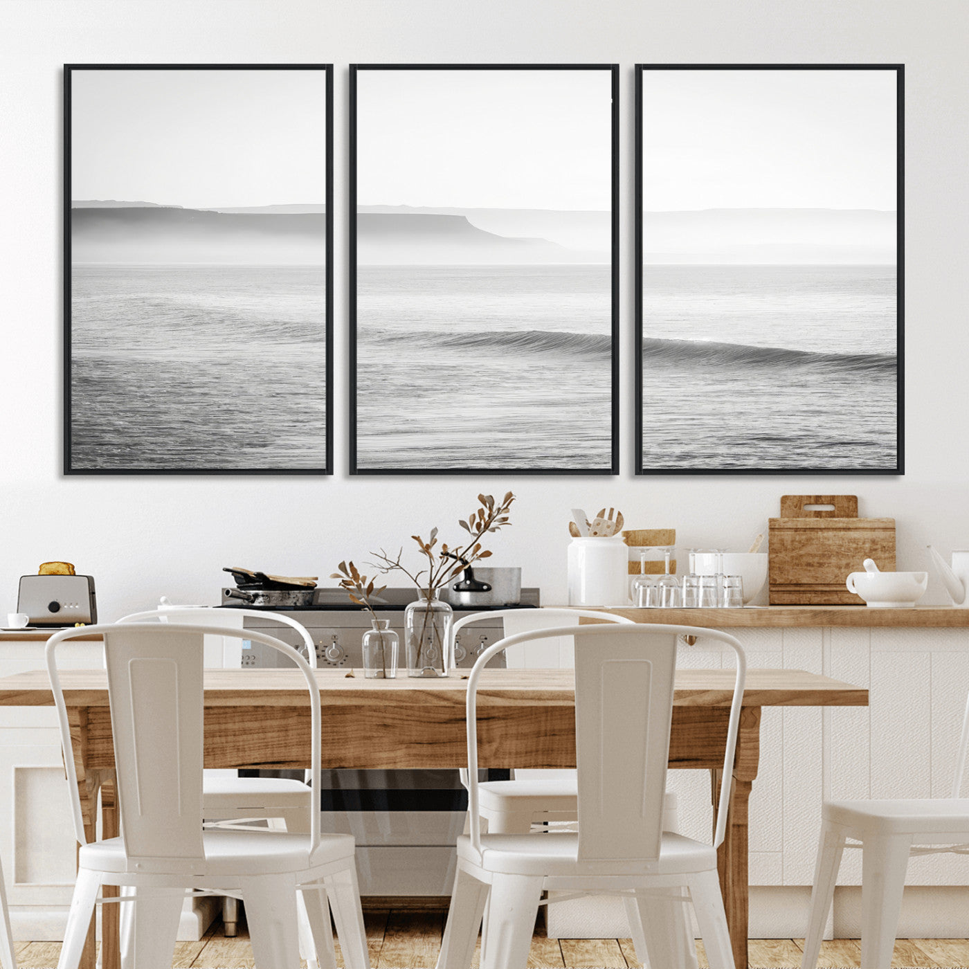 A black and white minimalist seascape featuring soft rolling waves and misty distant cliffs, creating a serene and timeless coastal atmosphere.
