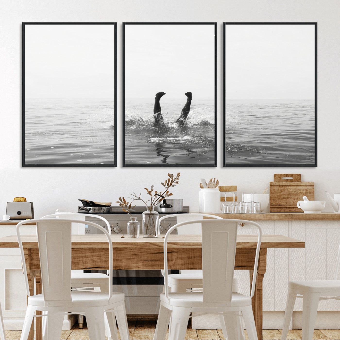 A black and white minimalist water scene capturing a playful splash as a swimmer dives upside down, creating a carefree and artistic aquatic aesthetic.