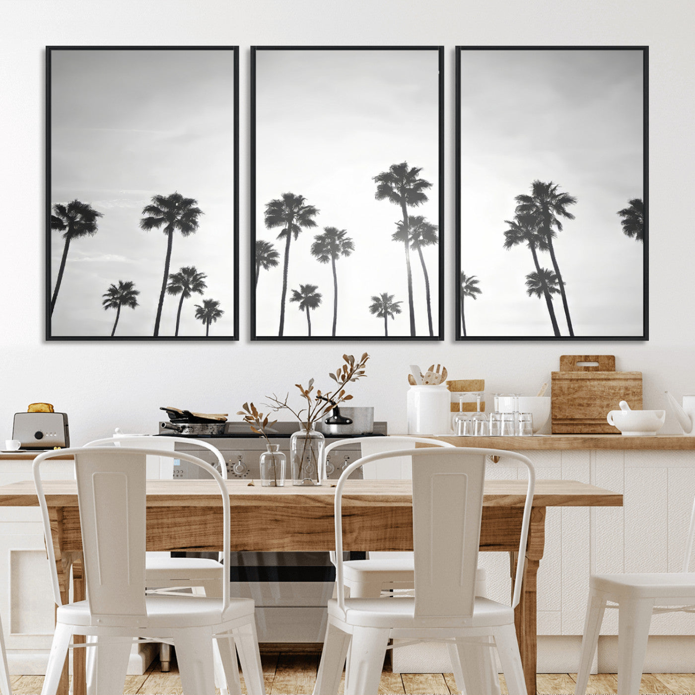 A black and white minimalist scene featuring tall palm trees silhouetted against a bright sky, creating a dreamy and timeless tropical aesthetic.