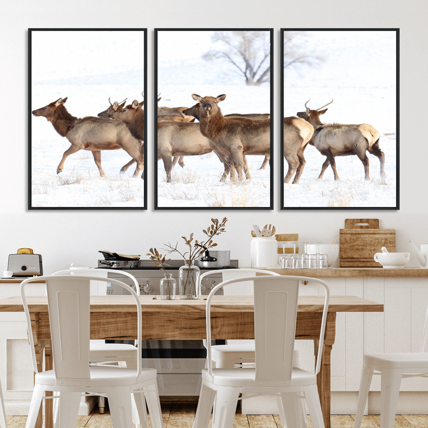 A group of elk standing on snowy terrain with a tree in the background, perfect for rustic or lodge-style winter wall decor.