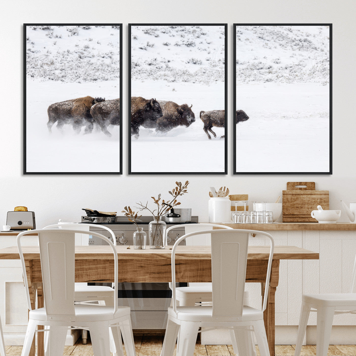 Bison herd running through a snowy open field with mountain backdrop, perfect for rustic or western-themed wall decoration.
