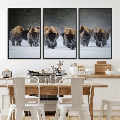 A herd of American bisons walking through deep snow in a forest, evoking a powerful rustic wilderness mood for western-style interiors.