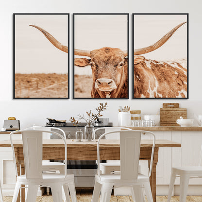 A longhorn bull standing proudly in a sunlit desert field with warm neutral tones, ideal for rustic western or farmhouse interiors.