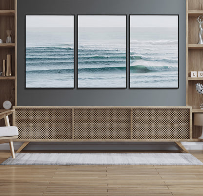 High-angle view of surfers lining up across layered ocean waves, ideal for minimal coastal or surf-inspired room decor.