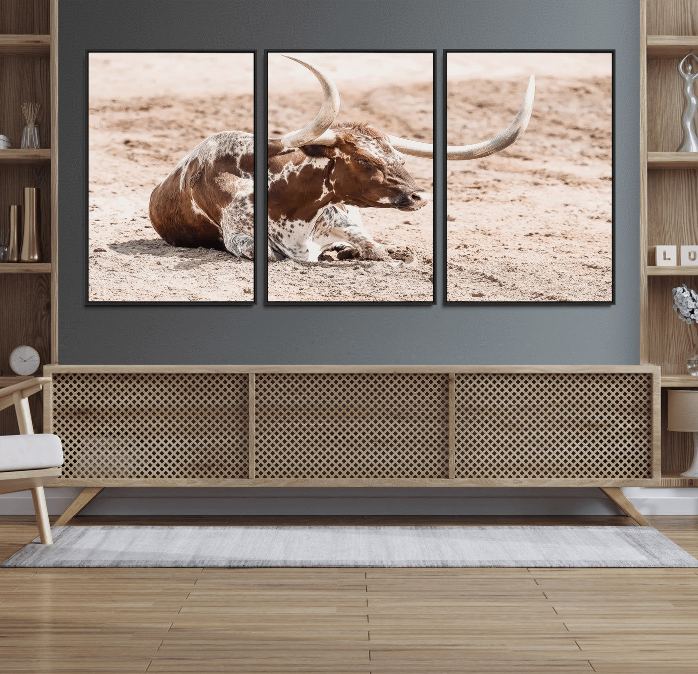 Texas Longhorn bull resting on dusty ground with warm tones, ideal for rustic western or farmhouse-themed wall decor.