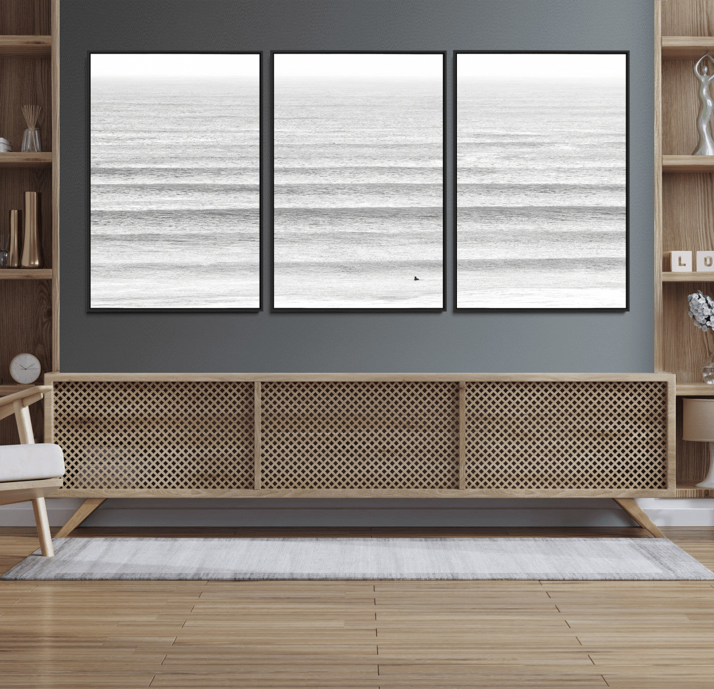 Monochrome photo of a lone surfer in calm layered waves, perfect for minimalist coastal or moody ocean-inspired wall decoration.