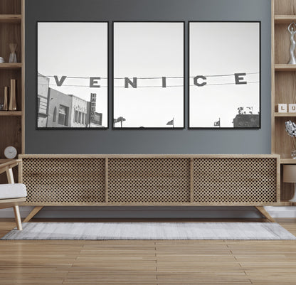Black and white photo of Venice Beach sign and palm-lined street, perfect for urban coastal or minimalist LA-inspired wall decoration.