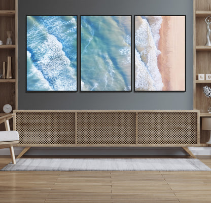 Aerial photo of soft blue waves meeting sandy shore, perfect for modern coastal or beach-themed decor with a light and tranquil aesthetic.