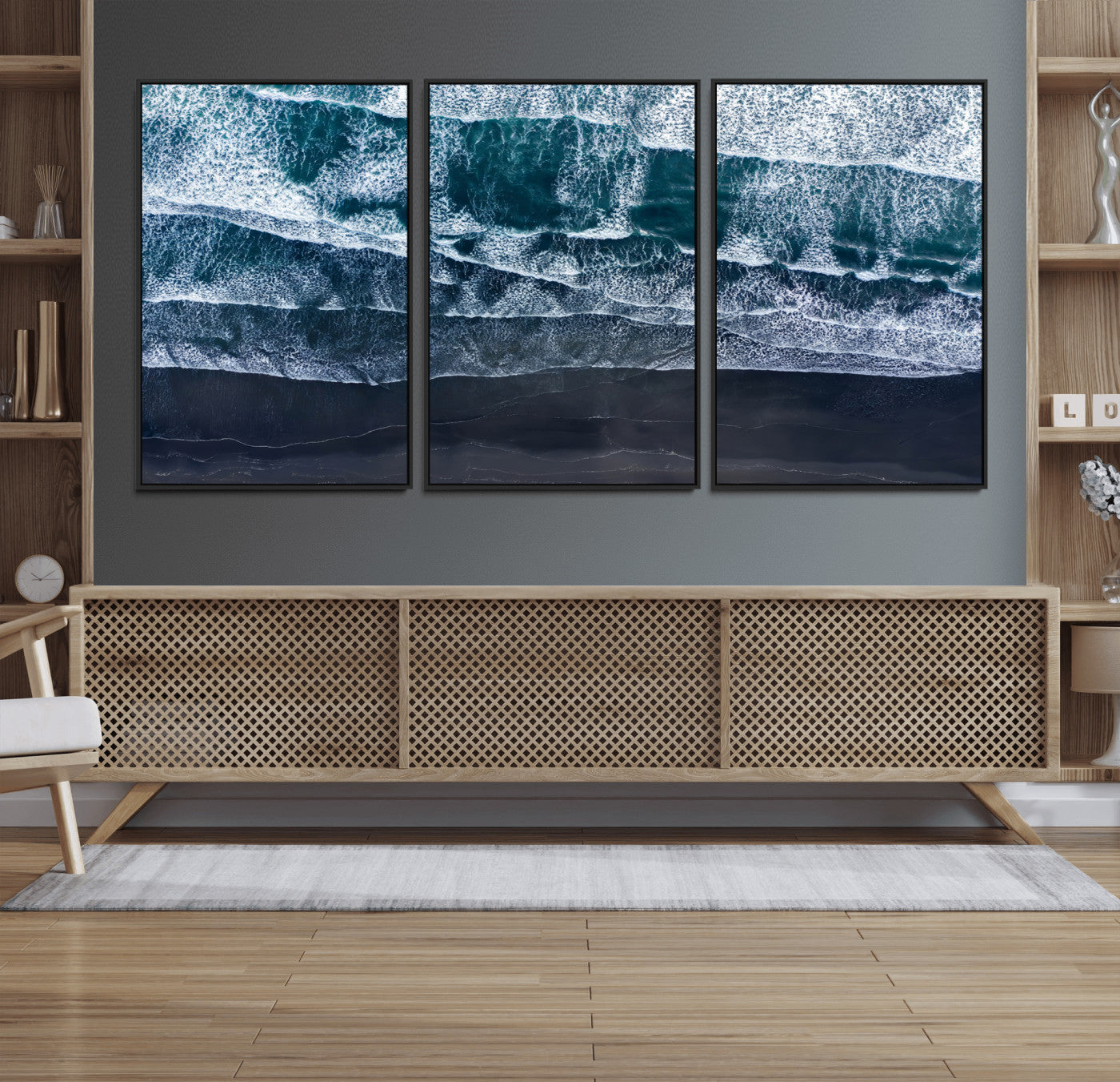 Canvas of aerial ocean waves crashing onto a black sand beach in moody tones, ideal for modern coastal or minimalist home decor.