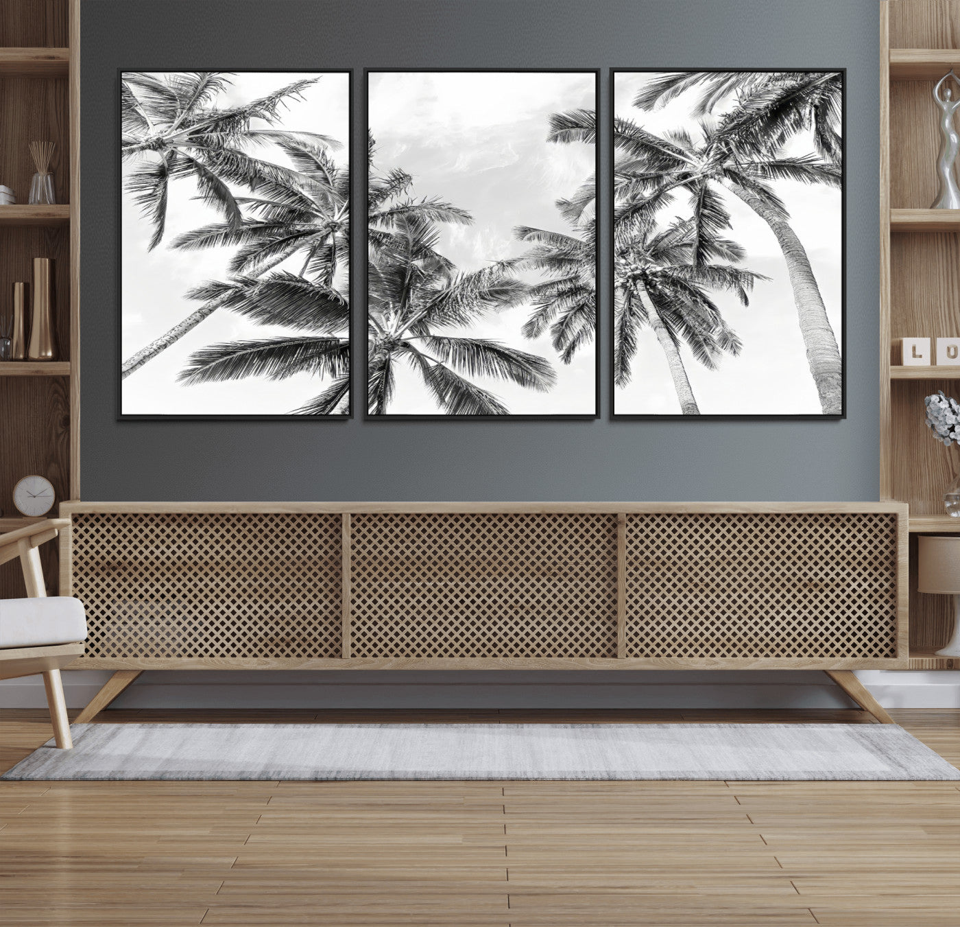 Black and white tropical palm trees viewed from below, swaying gently against a bright sky, creating a serene and elegant coastal atmosphere.
