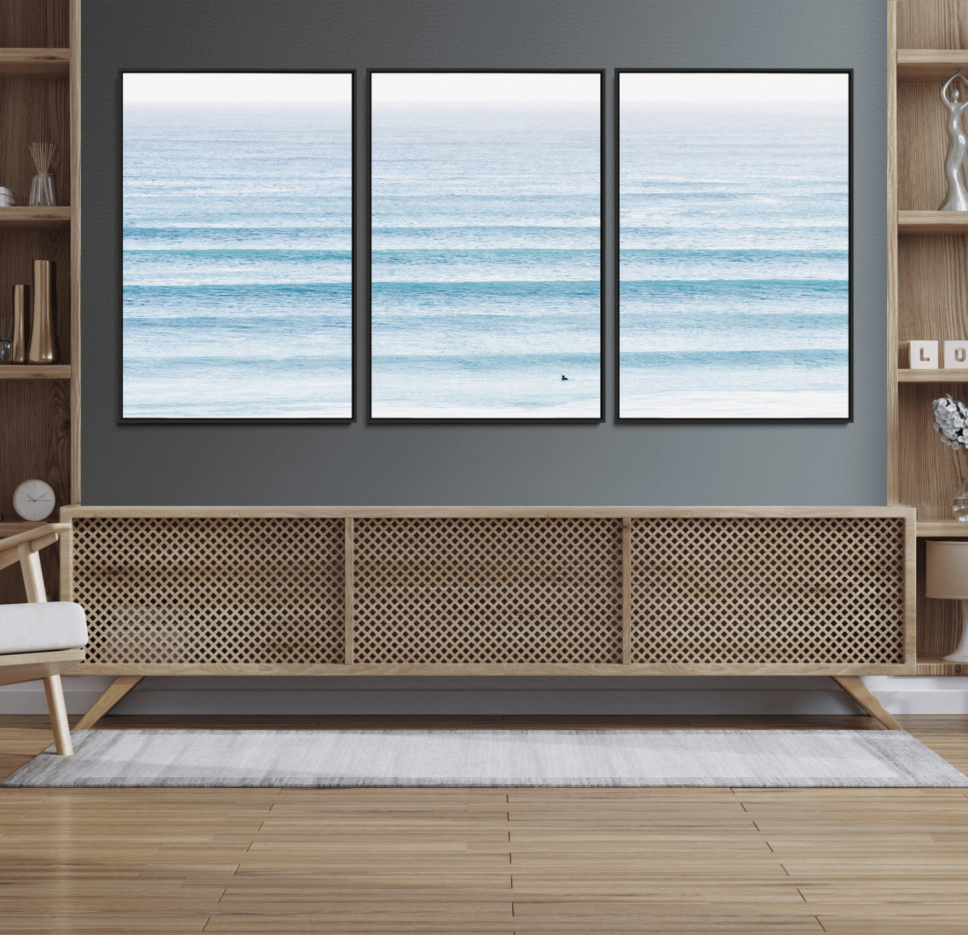 Minimalist ocean view with soft blue waves and a lone surfer, creating a serene and airy coastal aesthetic, perfect for tranquil home decor.