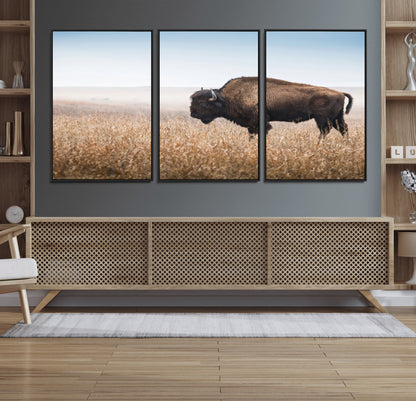A majestic bison standing in an open prairie field, its strong form blending into the golden grass under a vast blue sky, evoking the wild spirit of the American plains.