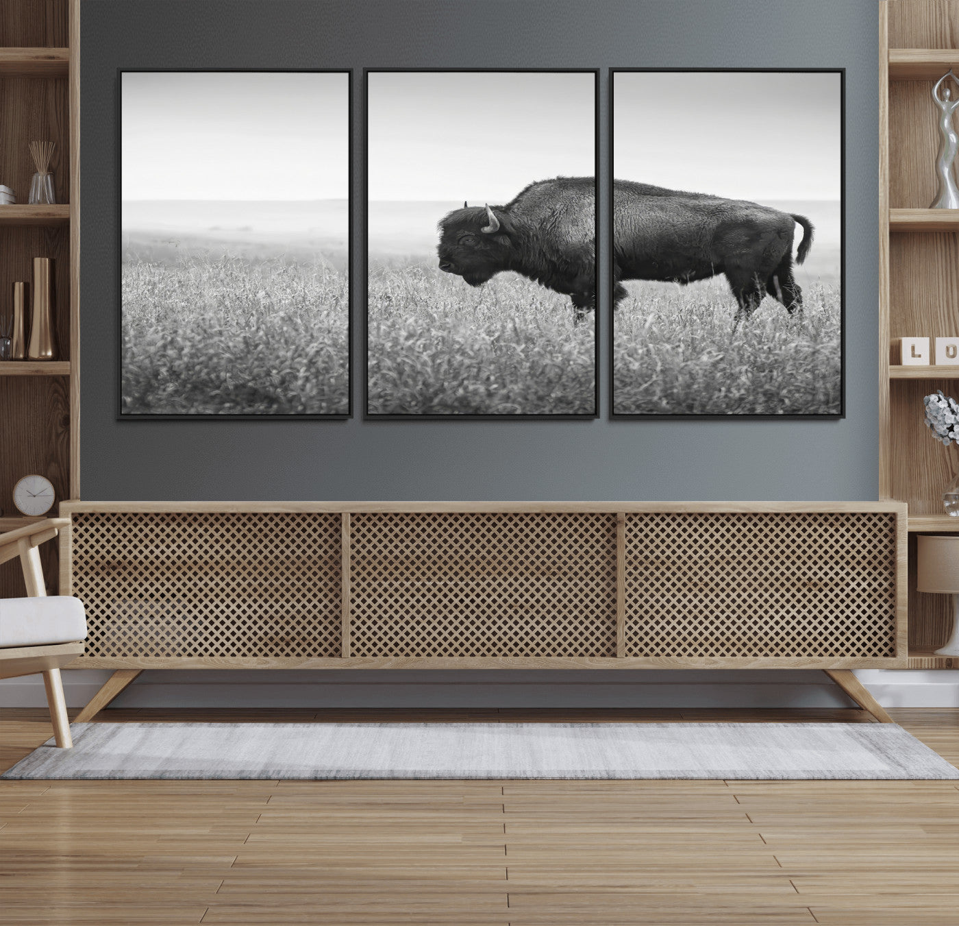 A black and white photograph of a majestic bison standing in a vast grassy prairie, evoking a sense of wilderness and strength.
