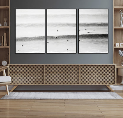 A monochrome photograph of swimmers gliding through gentle ocean waves, evoking a sense of calm and movement.