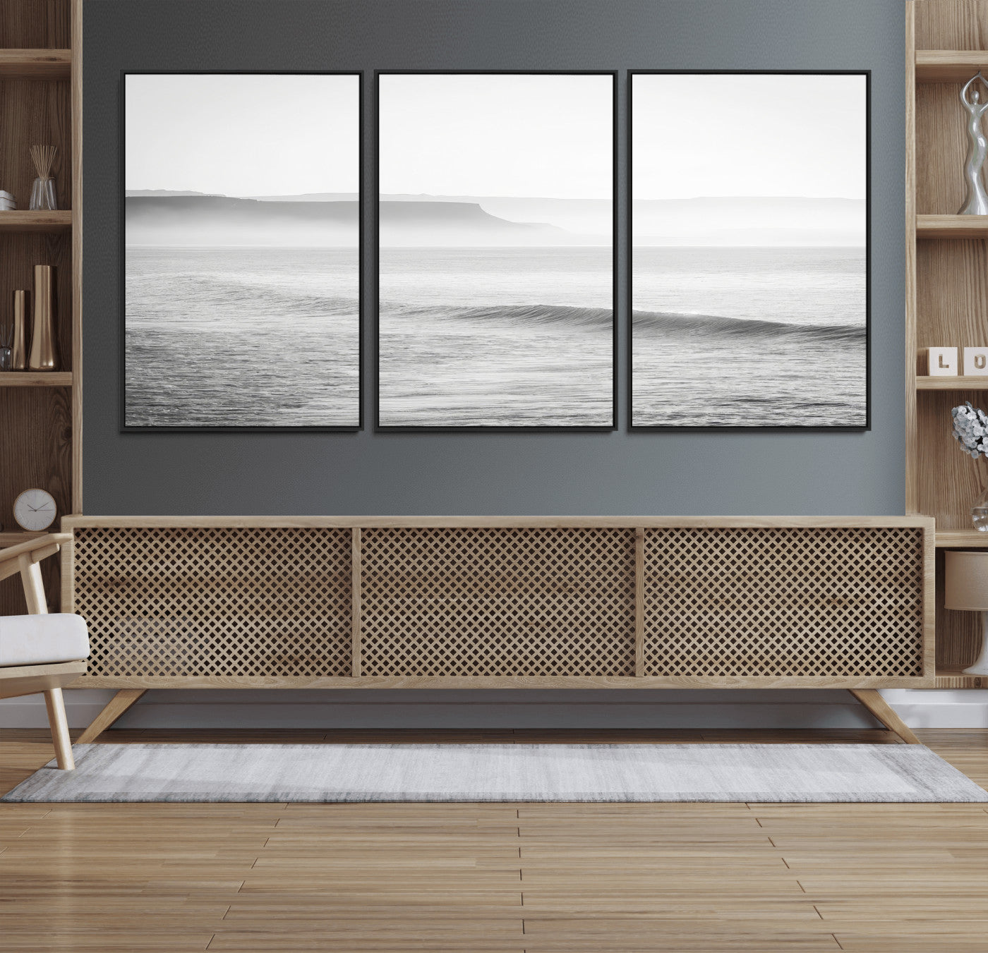 A black and white minimalist seascape featuring soft rolling waves and misty distant cliffs, creating a serene and timeless coastal atmosphere.