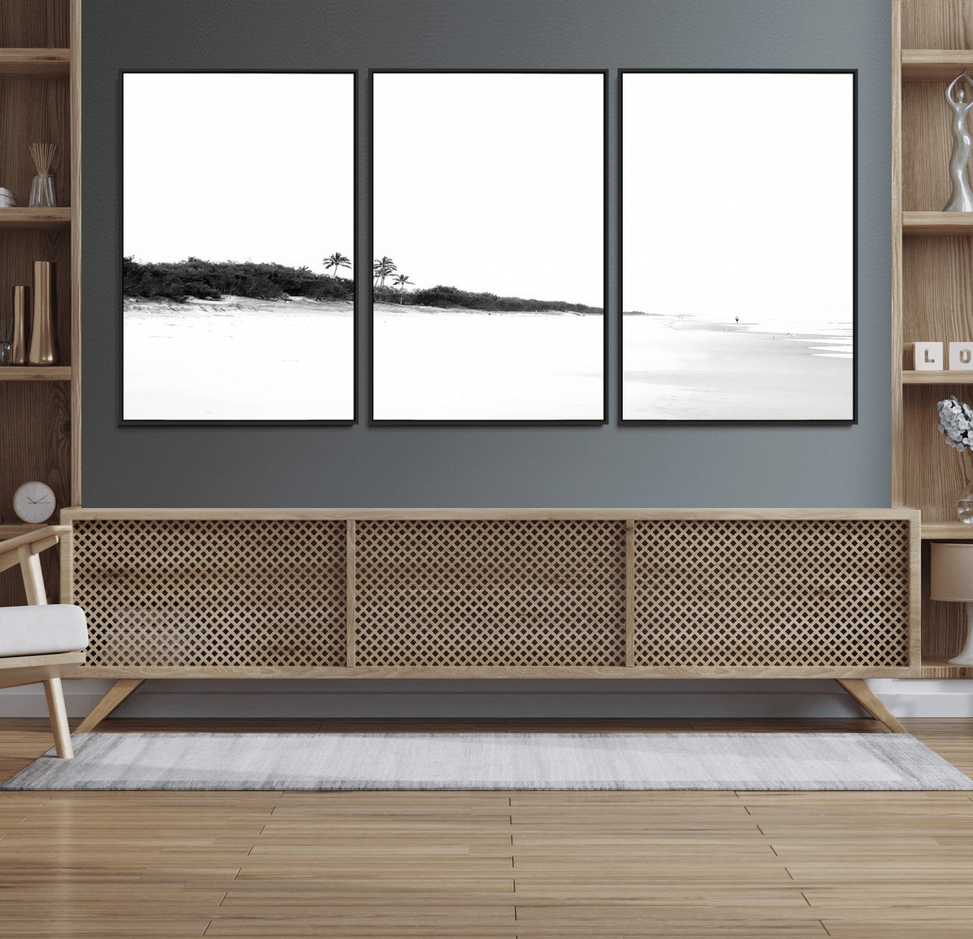 A black and white minimalist coastal scene with a vast open beach, distant palm trees, and a lone figure walking along the shoreline, evoking serenity and solitude.