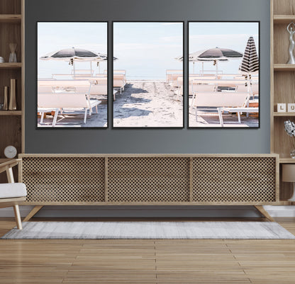 A serene minimalist beach scene featuring striped umbrellas, soft pastel sand, and an elegant lounge setup, creating a tranquil and stylish coastal retreat.