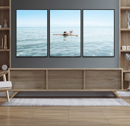A peaceful minimalist scene of a person floating on crystal-clear water, surrounded by a vast open horizon, capturing relaxation and serenity in a tranquil aquatic setting.