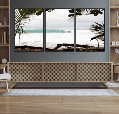 Tropical beach view with palm trees and surfer riding a wave, perfect for boho or coastal-inspired interior wall decor.