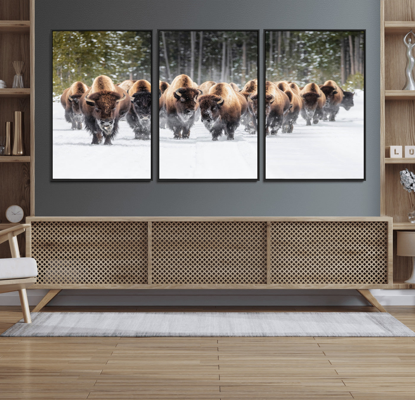 A herd of American bisons walking through a snowy forest path, perfect for rustic cabin or Western-themed wall decor.