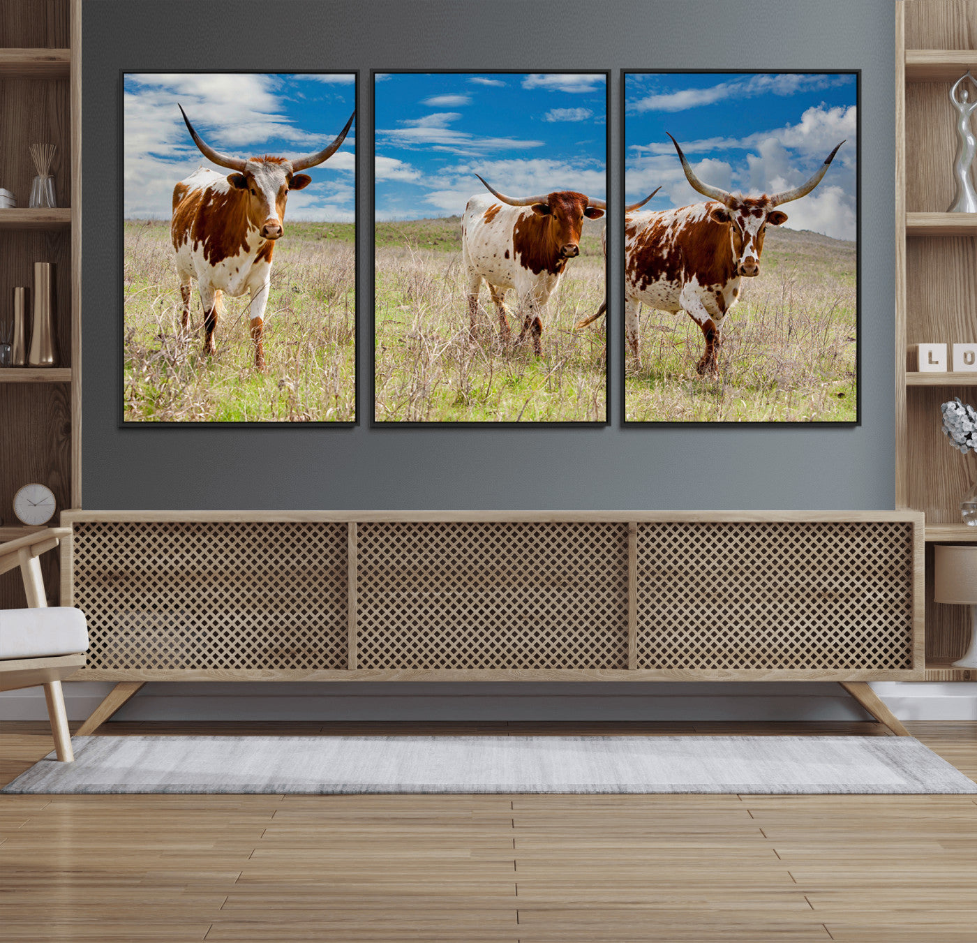 Three Texas longhorn cattle standing in dry grass under a bright blue sky, ideal for farmhouse or western rustic home decor.