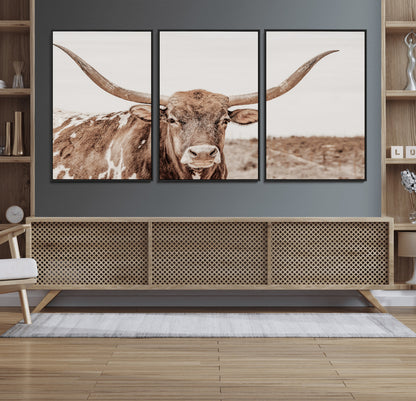 A longhorn cow in soft beige desert tones, standing calmly in open land, perfect for neutral western or rustic farmhouse interiors.