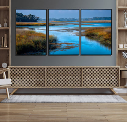 A peaceful marshland scene with calm blue water reflecting the surrounding grasses and trees, capturing the beauty of nature in a serene landscape.