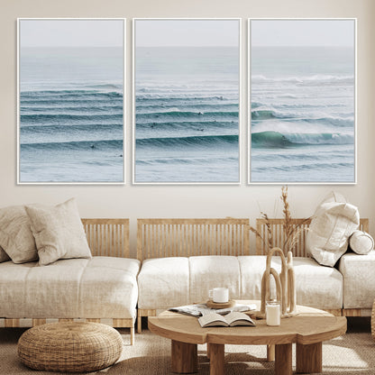 High-angle view of surfers lining up across layered ocean waves, ideal for minimal coastal or surf-inspired room decor.