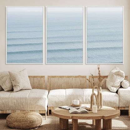 Framed canvas of repeating ocean waves with a distant solo surfer, ideal for minimalist ocean or calm coastal wall decor.