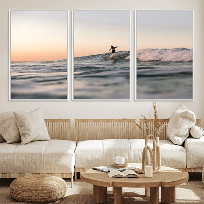 Framed canvas of a female surfer balancing on a wave at sunset, perfect for serene surf or ocean-inspired coastal decor.