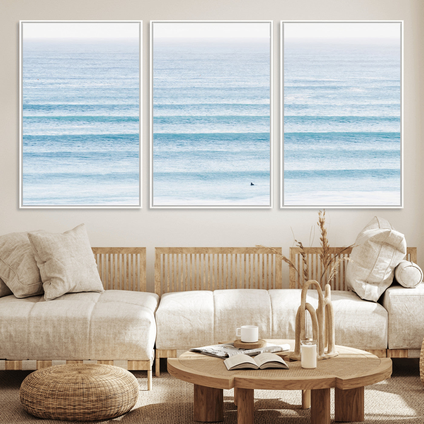 Minimalist ocean view with soft blue waves and a lone surfer, creating a serene and airy coastal aesthetic, perfect for tranquil home decor.
