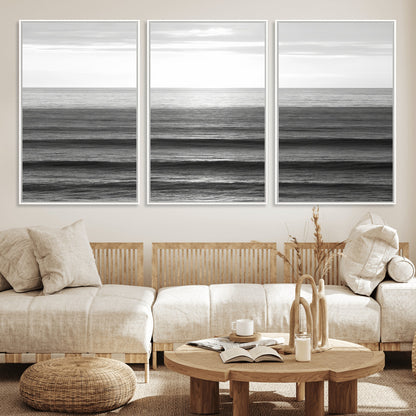 Minimalist black and white ocean view with layered waves reflecting sunlight, evoking a sense of calm and coastal serenity.