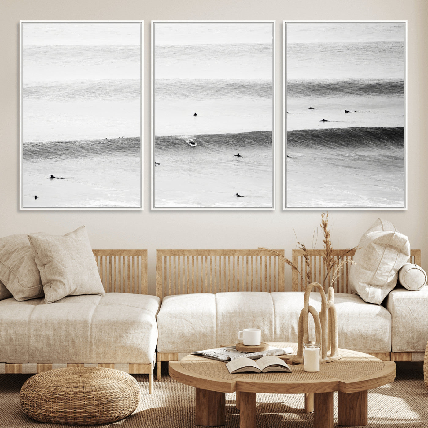 A monochrome photograph of swimmers gliding through gentle ocean waves, evoking a sense of calm and movement.