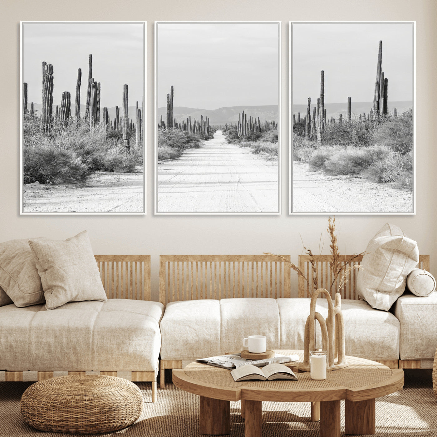 A black and white desert road stretching through a cactus-filled landscape, creating a rugged and timeless southwestern aesthetic with a sense of adventure.