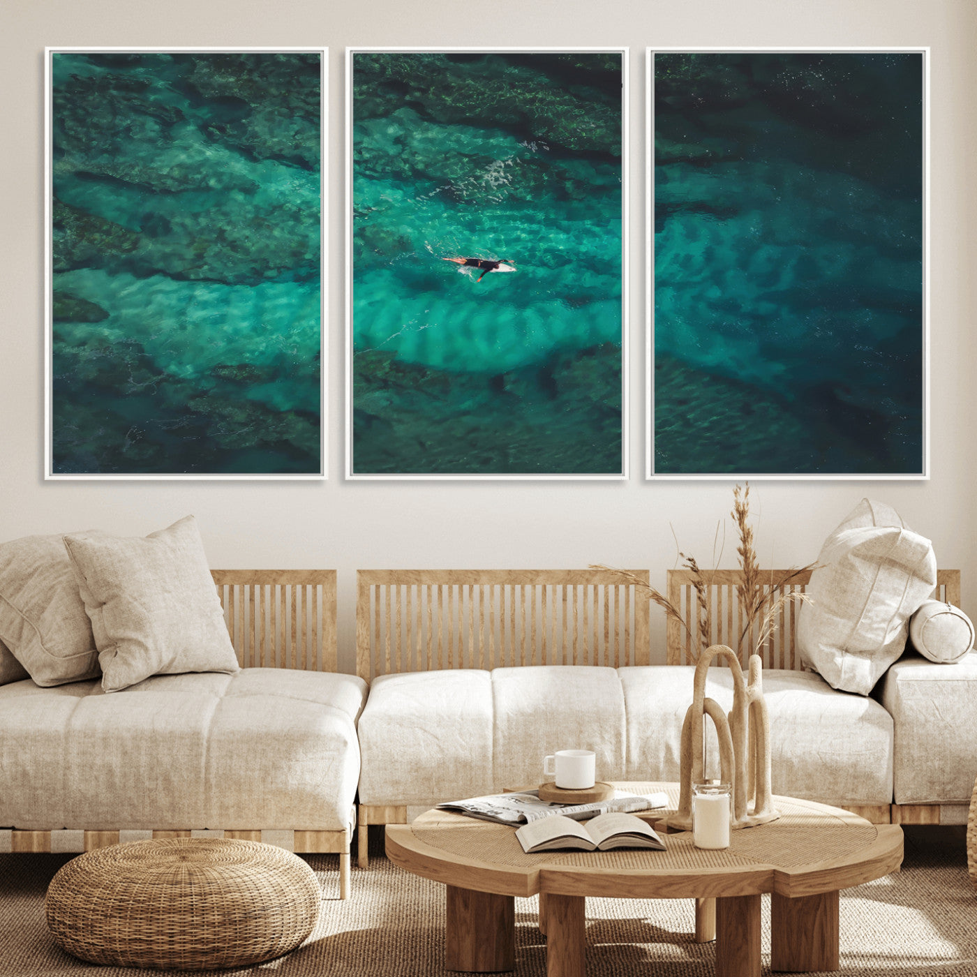 An aerial view of a solo surfer paddling through crystal-clear turquoise waters over a sunlit reef, capturing the beauty and serenity of open water surfing.