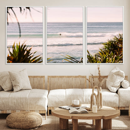 Canvas of a lone surfer riding a pastel wave at sunrise, perfect for tropical or coastal-themed spaces with a relaxed, airy vibe.