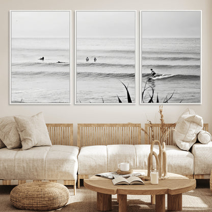 Monochrome canvas of surfers on calm ocean waves, ideal for minimalist coastal or beach-inspired interior decor.