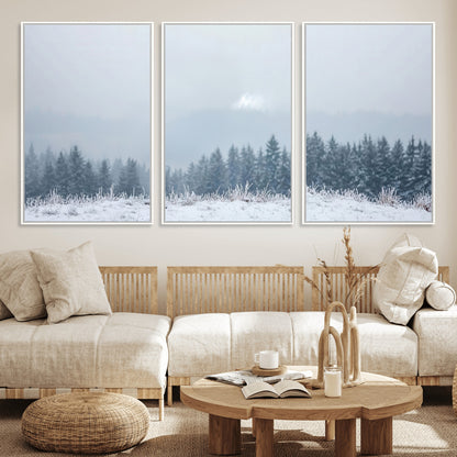 Snow-covered forest under misty sky, soft light breaking through clouds, ideal for minimalist or Nordic-inspired home decor.