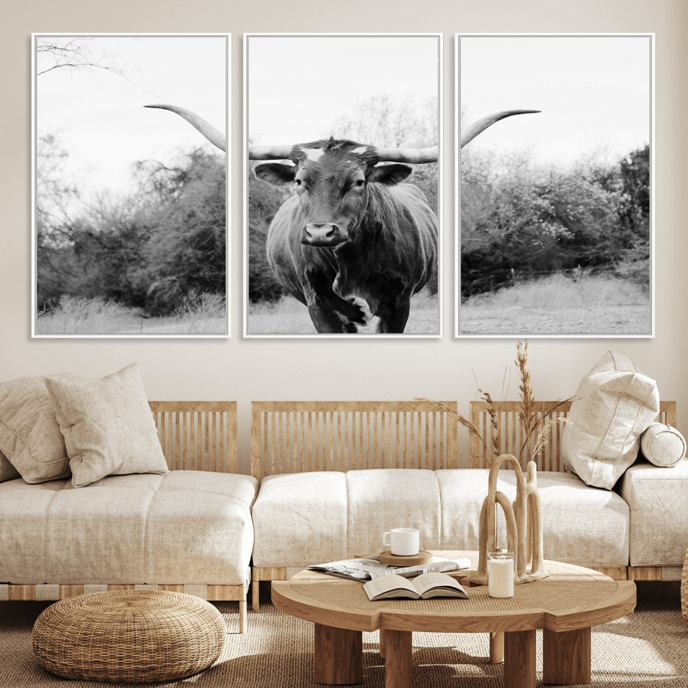 Black and white photo of a longhorn cow in a field, perfect for rustic farmhouse or western-themed interior wall decoration.