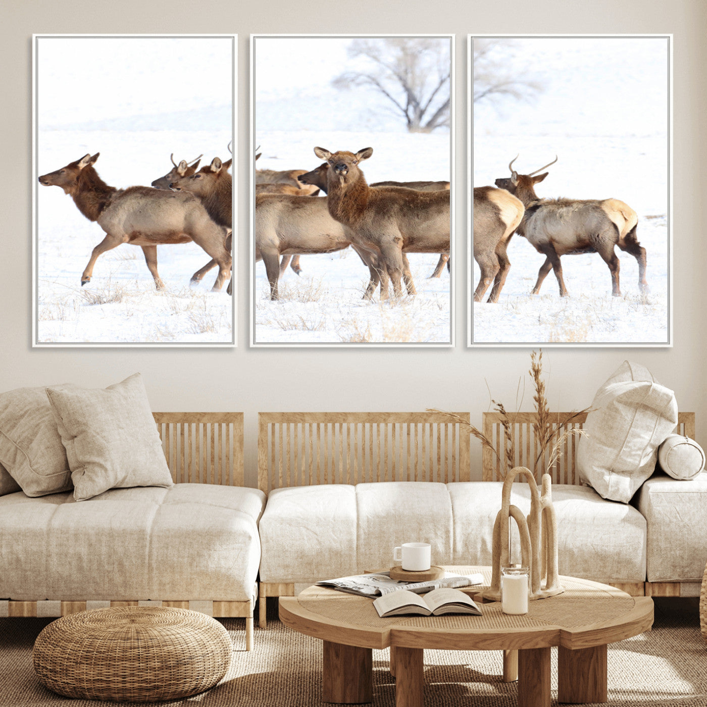 A group of elk standing on snowy terrain with a tree in the background, perfect for rustic or lodge-style winter wall decor.