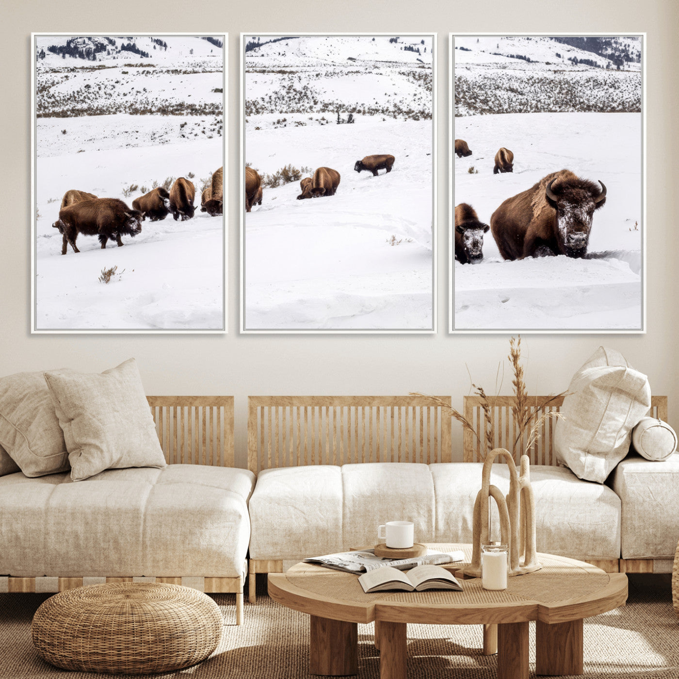 A herd of bison walking through deep snow in a mountain valley, perfect for rustic, cabin or western-themed wall decor.